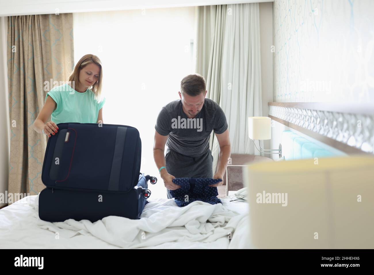 A couple in the room are packing things Stock Photo