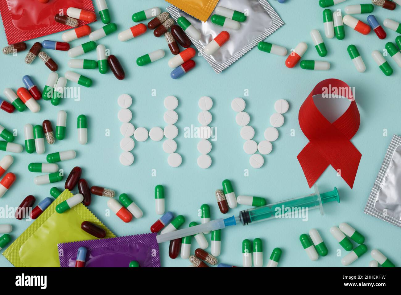 The word HIV is written with pills, red ribbon Stock Photo - Alamy