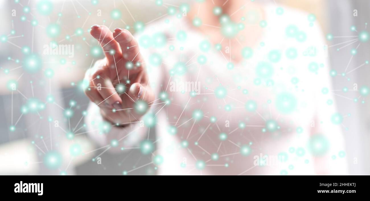 Woman touching a virtual network on a touch screen with her fingers ...