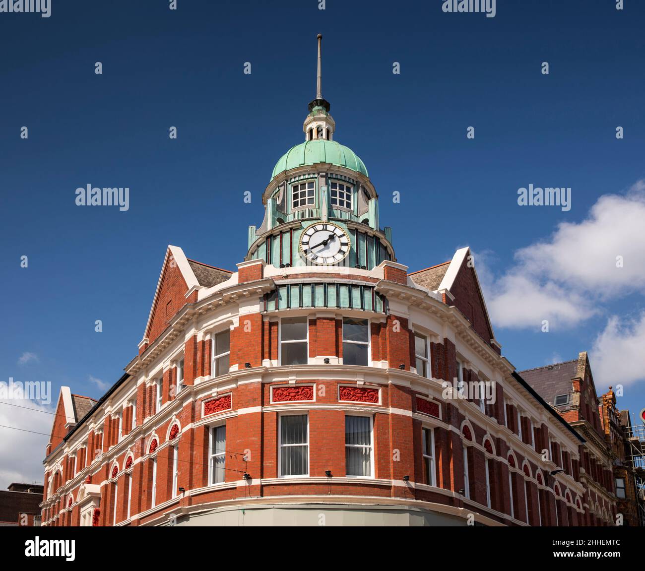 UK, Wales, Merthyr Tydfil, High Street, domed clock tower of curved shop building Stock Photo