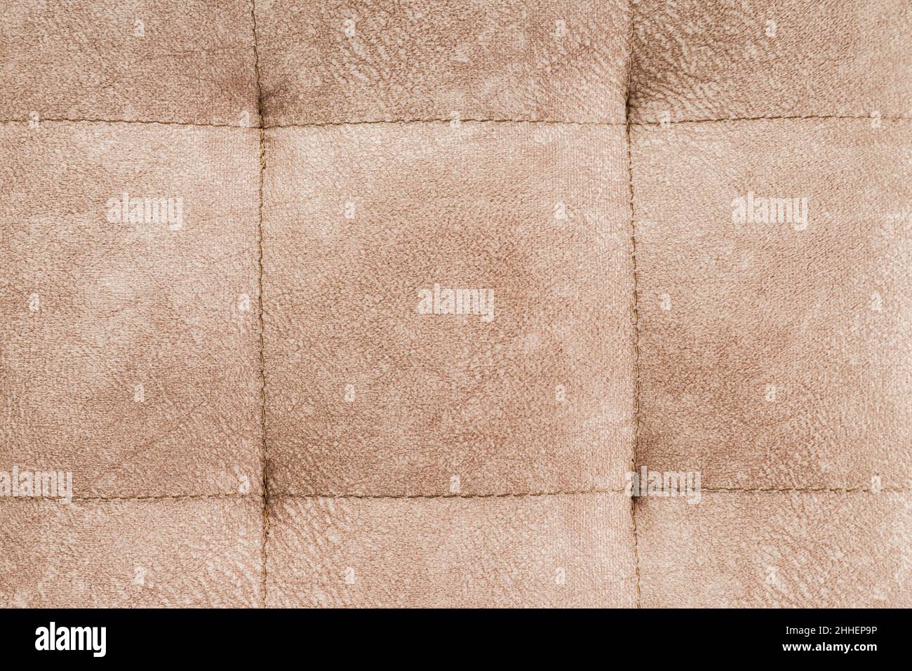 Texture brown fabric. Background of a soft pouf. Stock Photo
