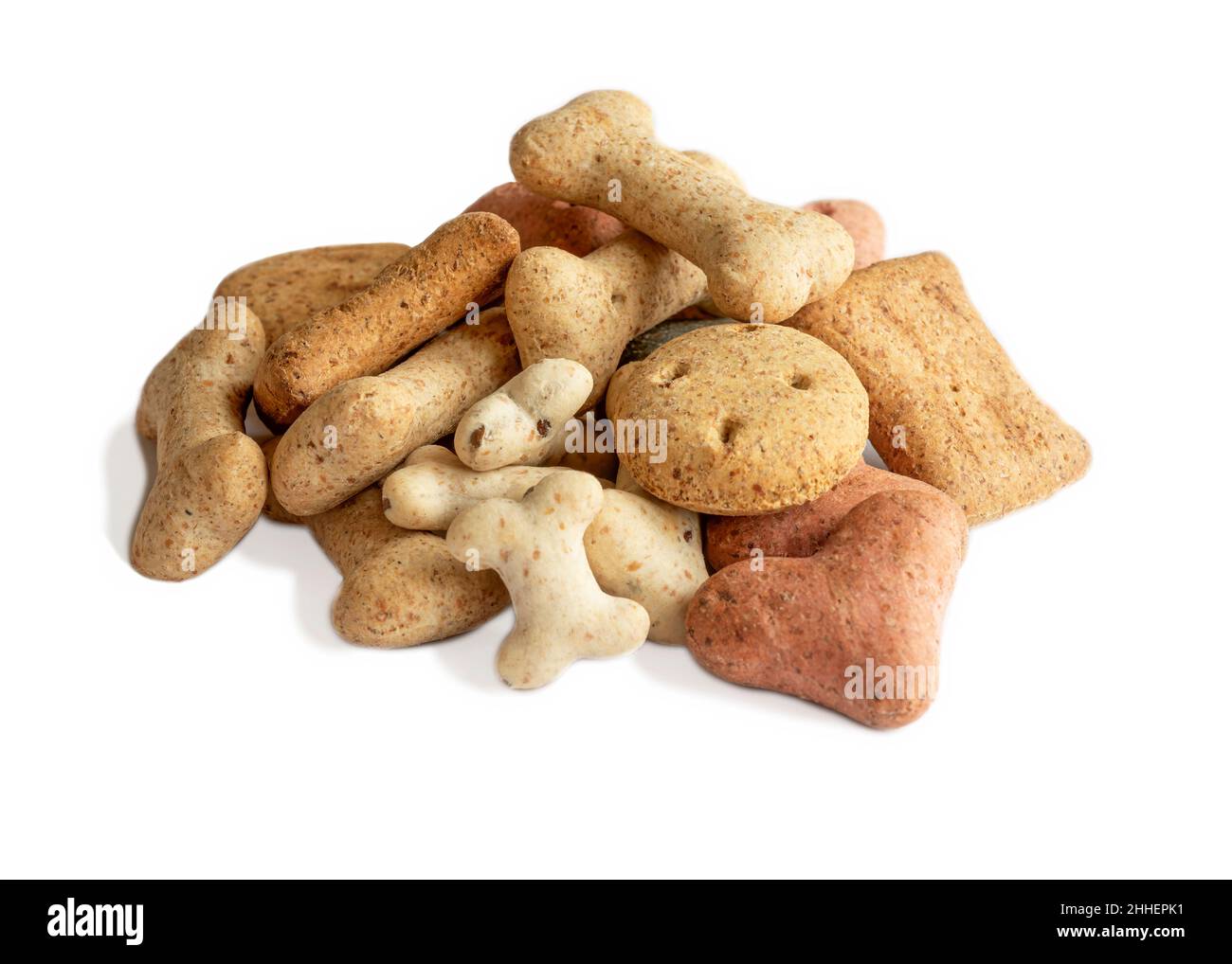 healthy tasty dog biscuits treats different shapes in a pile used for training and occasions on a white isolated background  macro shot Stock Photo