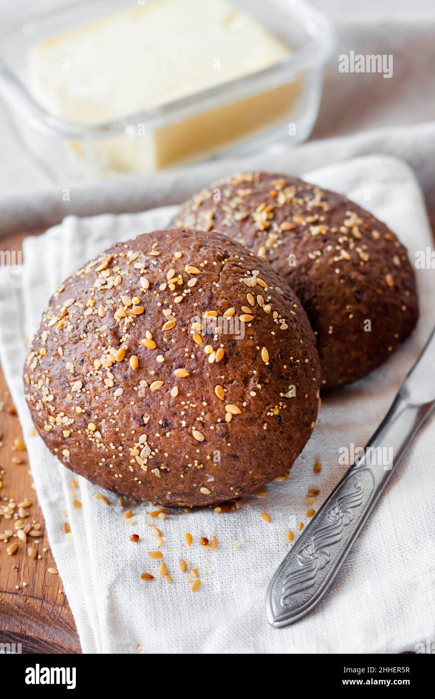Mini Rye Buns Homemade rye buns with linseeds, sesame and white poppy seeds on wooden ...