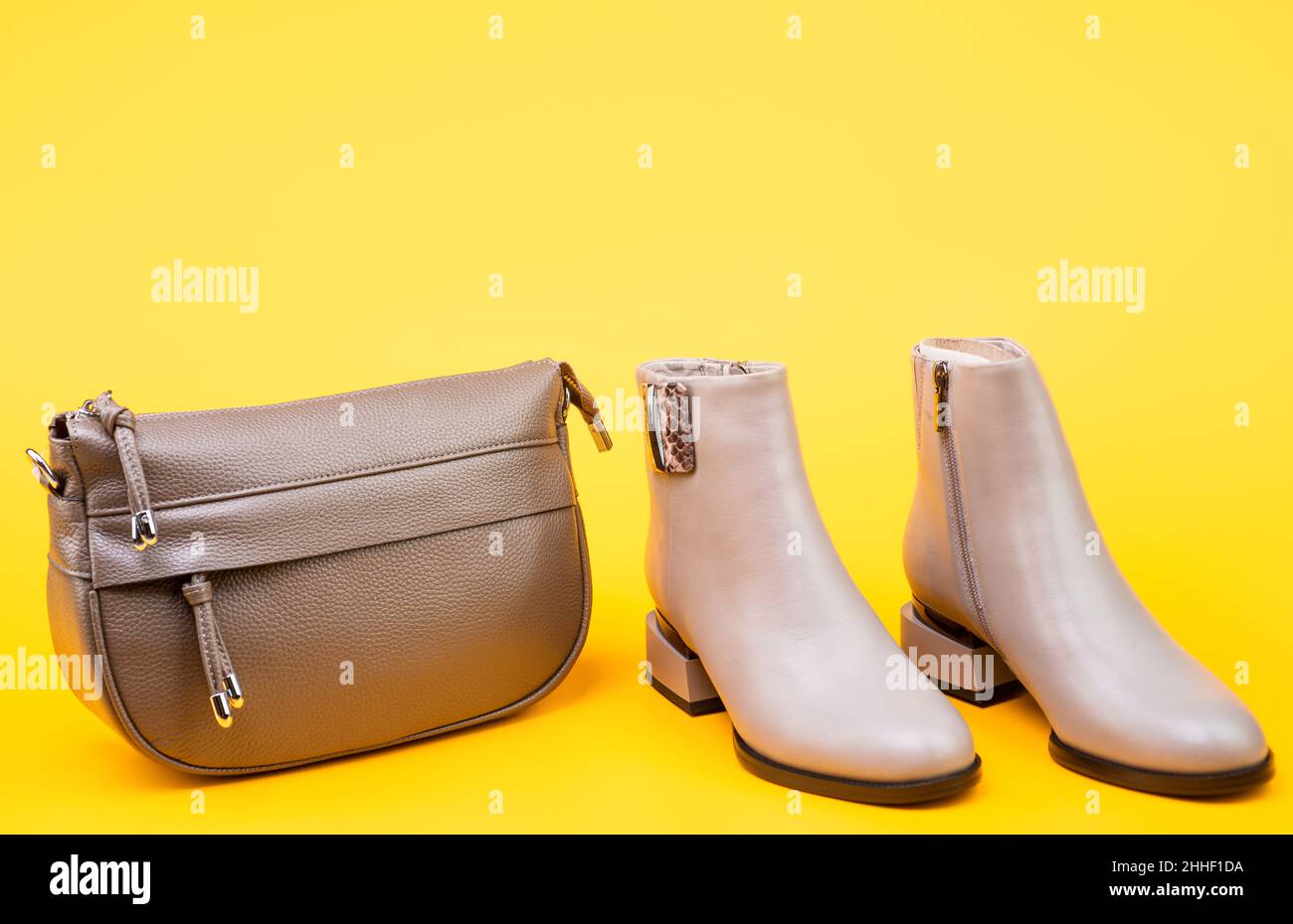 beige boots. ankle boots on yellow background. shoe store. shopping concept. Stock Photo