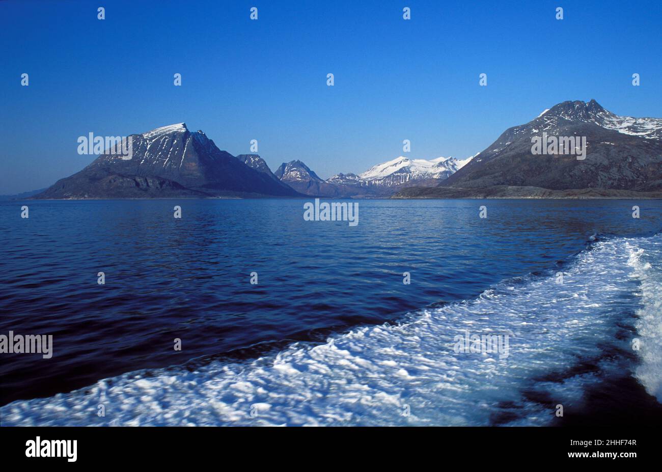 View of the straight between Aldra and mainland in bright sunshine in 1991, analog. Mountains and blue sky. Stock Photo
