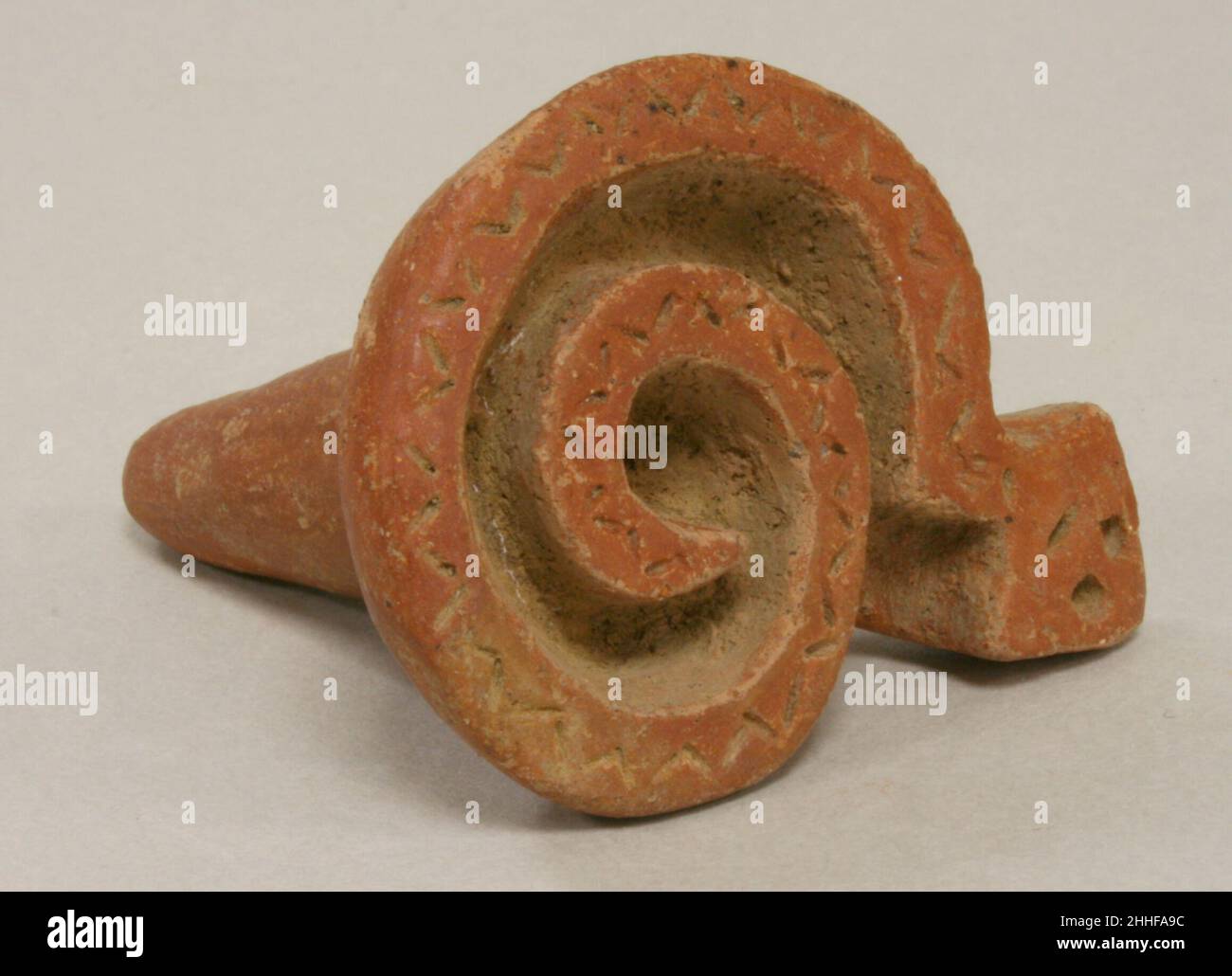 Serpent Stamp 1st–7th century Atlantic Watershed Ceramic stamps are found in Costa Rican burials, suggesting that their importance extended beyond utilitarian. Much speculation has been made with regard to the material that these stamps were intended to imprint, including paper, textiles, and the human body. The curved shape of the printing surface supports the function of body painting most strongly. This theory is reinforced by the presence of stamp motifs on Costa Rican ceramic figure sculpture. The designs of the stamps can be divided into two categories, those that mimic the geometricity Stock Photo