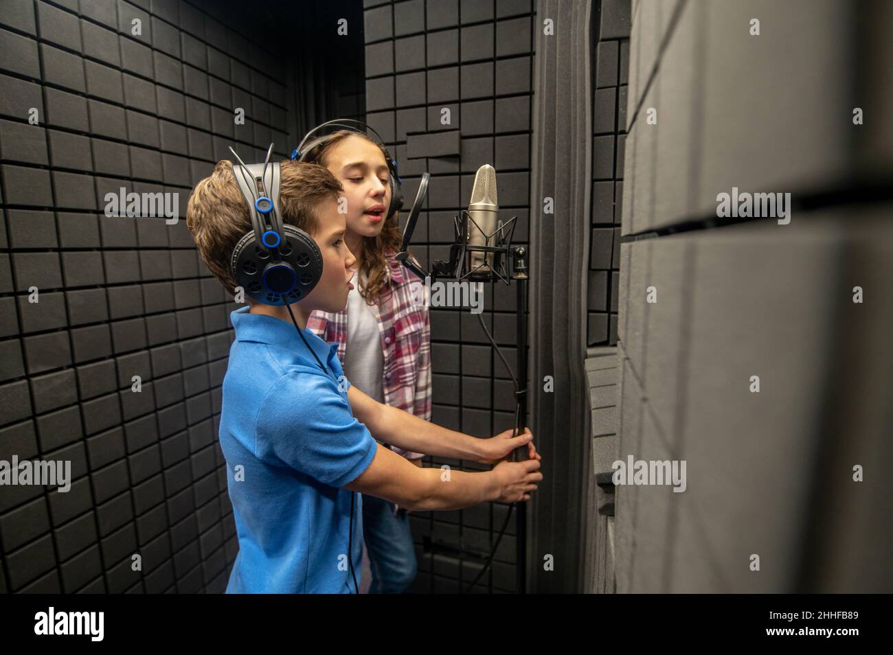 Two children recording a song in a modern studio Stock Photo Alamy