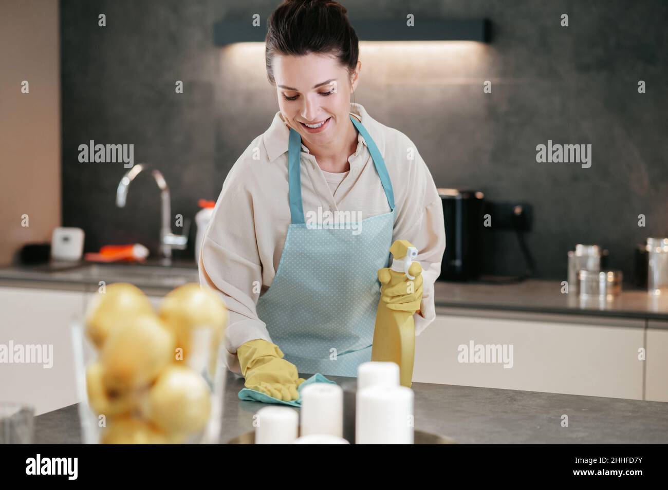 Young dark-haired woman looking busy while doing housework Stock Photo ...