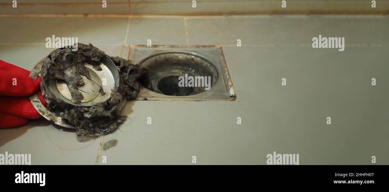 Drain cleaning. Clogged and dirty sewer pipes floor drain. Full of hair