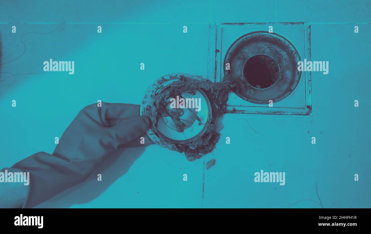 Drain cleaning. Clogged and dirty sewer pipes floor drain. Full of hair