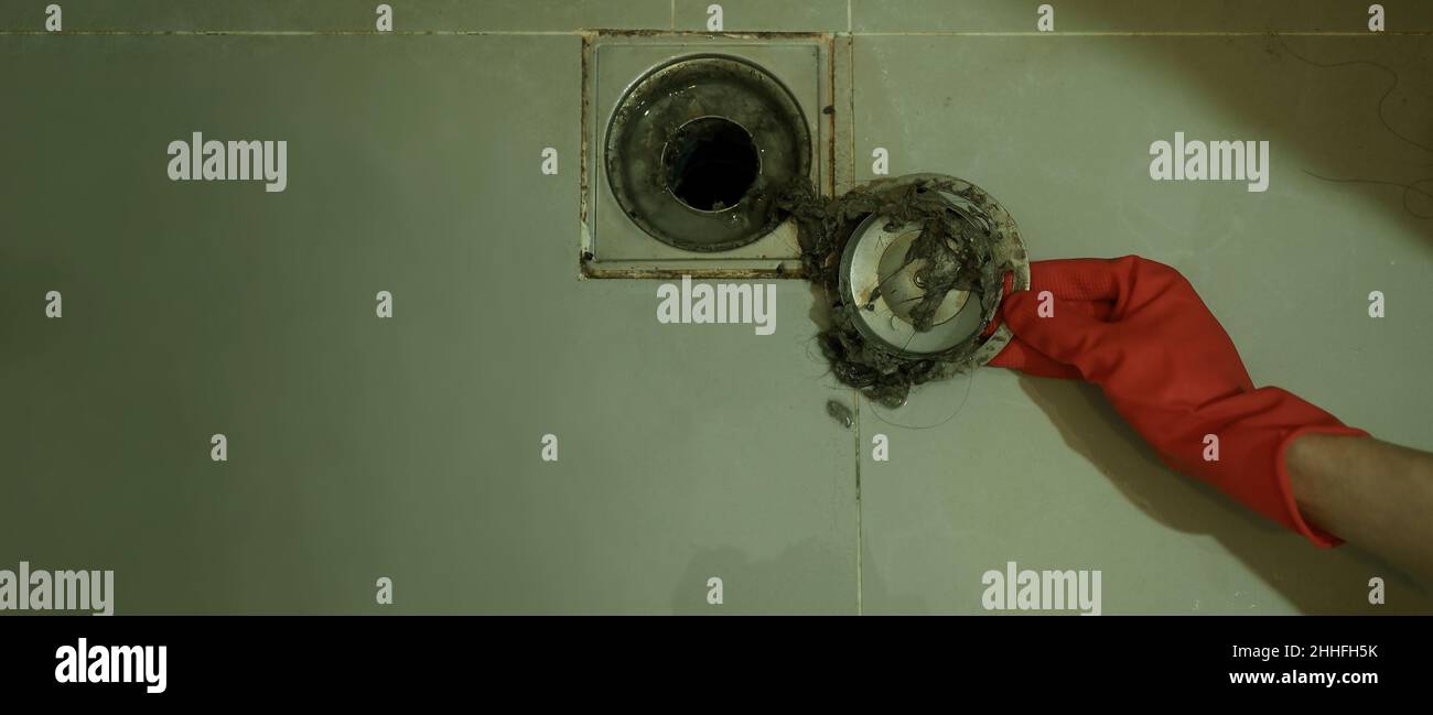 Drain cleaning. Clogged and dirty sewer pipes floor drain. Full of hair