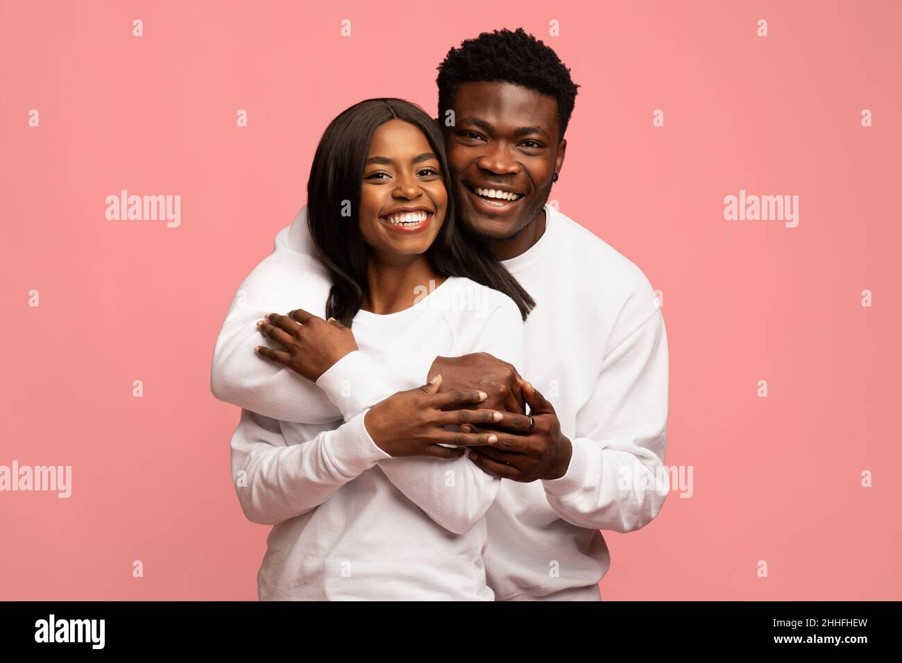 Loving african american man hugging his pretty wife Stock Photo - Alamy