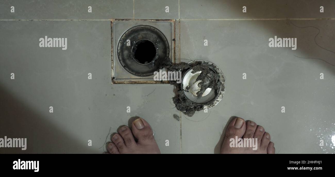 Drain cleaning. Clogged and dirty sewer pipes floor drain. Full of hair