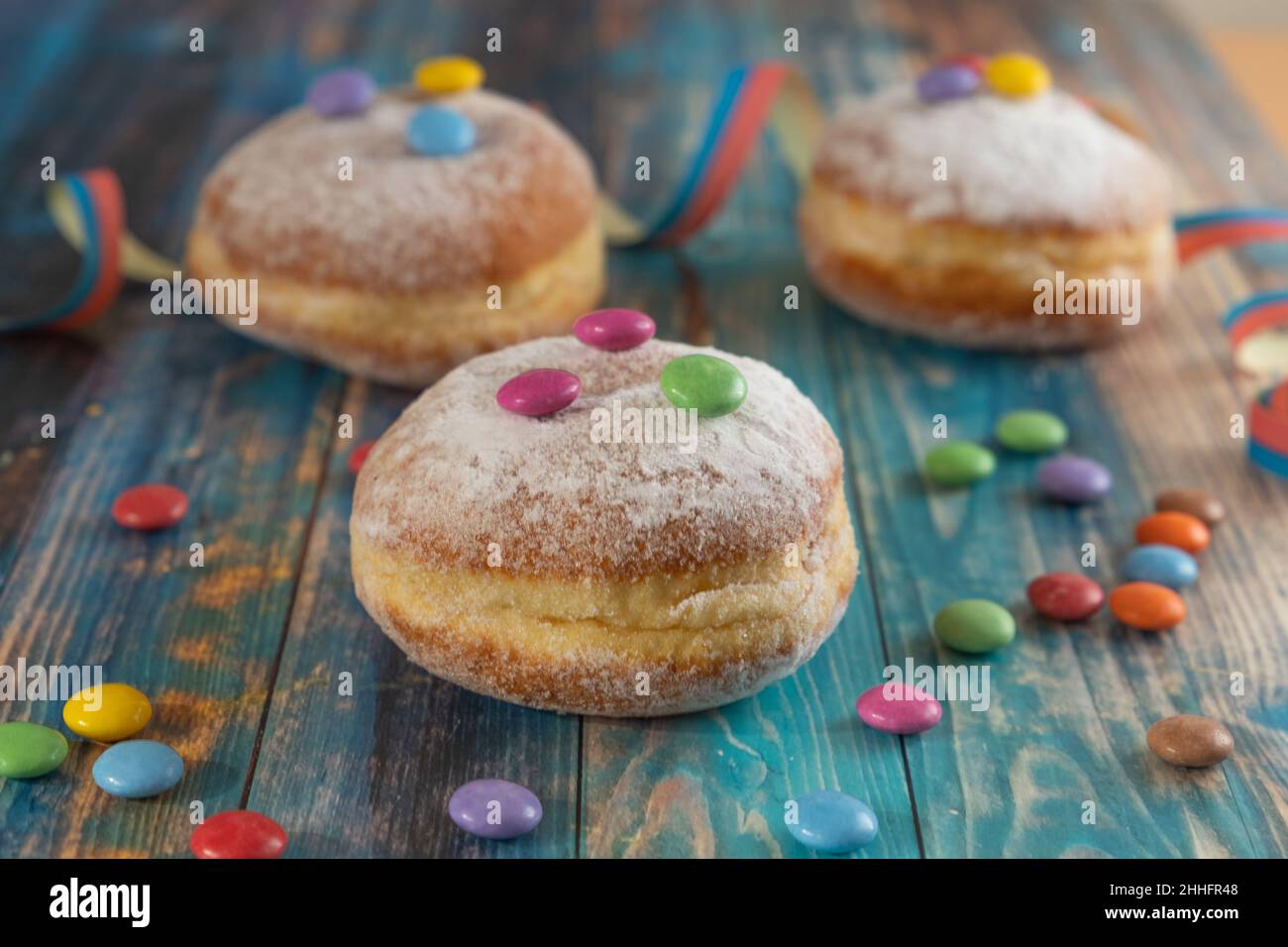 Berliner, Krapfen, doughnut are traditional sweet food for carnival, focus on foreground Stock Photo