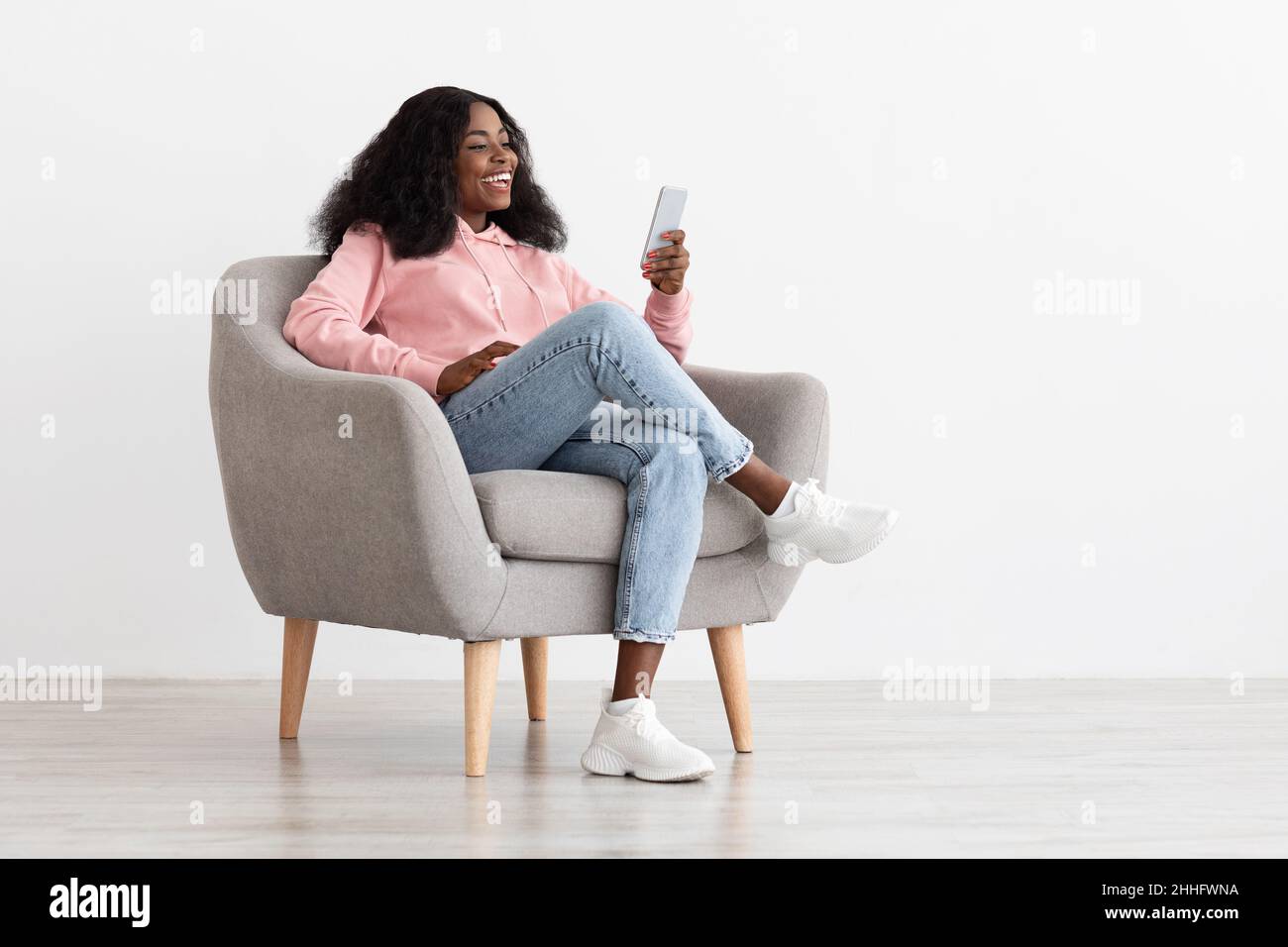 Positive pretty black lady having video call on smartphone Stock Photo ...