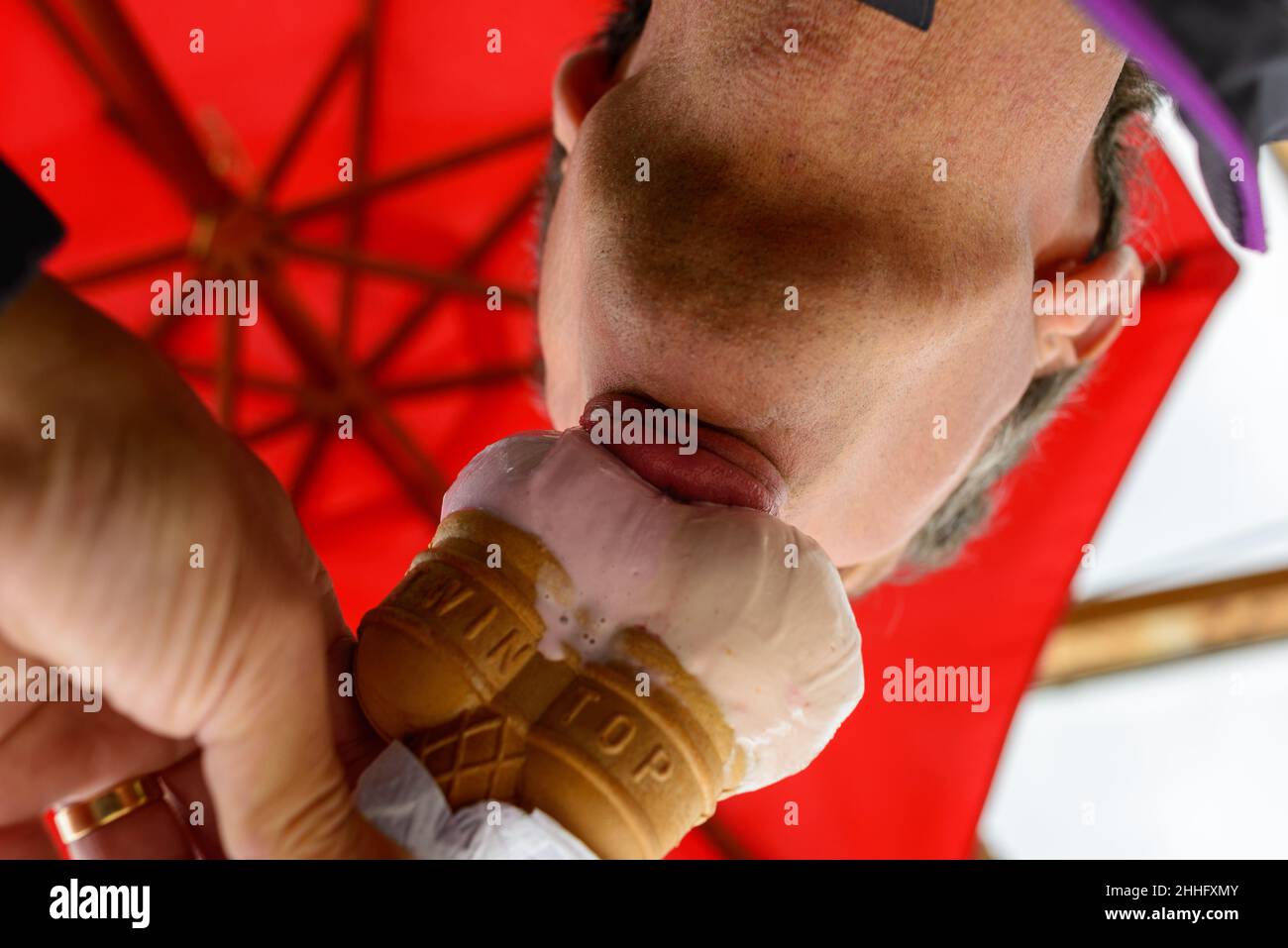 Eating an ice cream cone, view from below, underneath, looking up Stock Photo