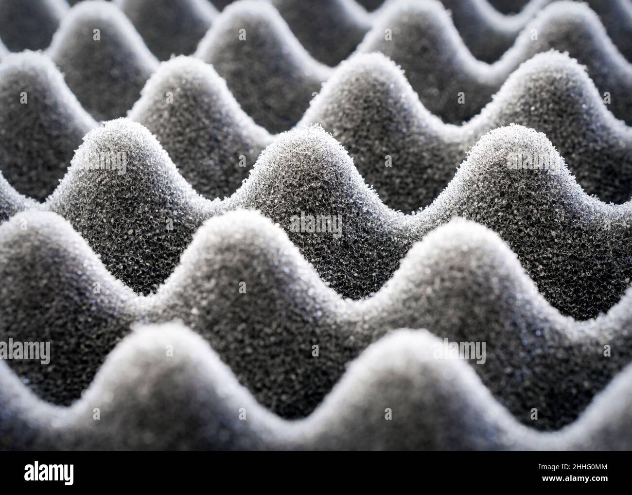 Light play on black egg crate foam.  Close up view. Stock Photo