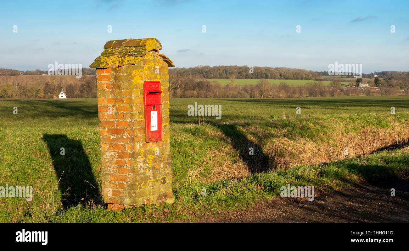 A post box mounted in a custom built brick tower with small tiled roof Stock Photo