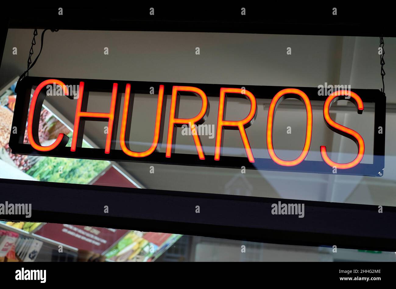 red neon churros sign in takeaway cafe window, norfolk, england Stock Photo