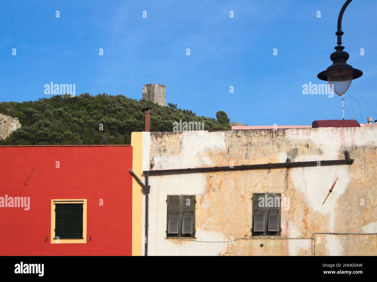 houses in Varigotti and the Saracen Tower in Punta Crena in the background, Liguria, Italy Stock Photo