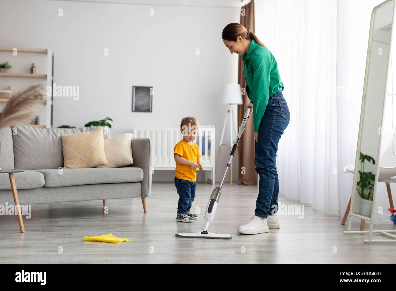 Young child doing house chores at home. Asian baby boy sweeping floor with  broom Stock Photo - Alamy