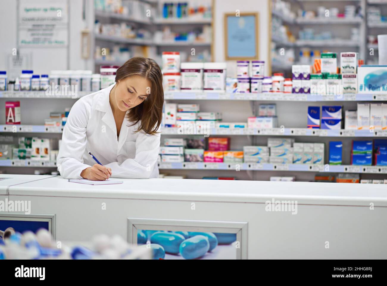 Ensuring every prescription is correct. Shot of an attractive young pharmacist working at the prescription counter. Stock Photo