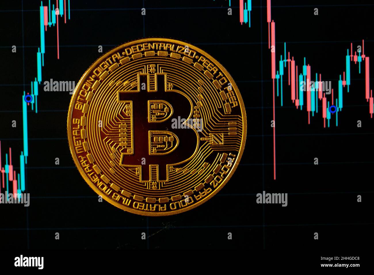 Berlin, Germany. 24th Jan, 2022. A Bitcoin coin lies on a screen