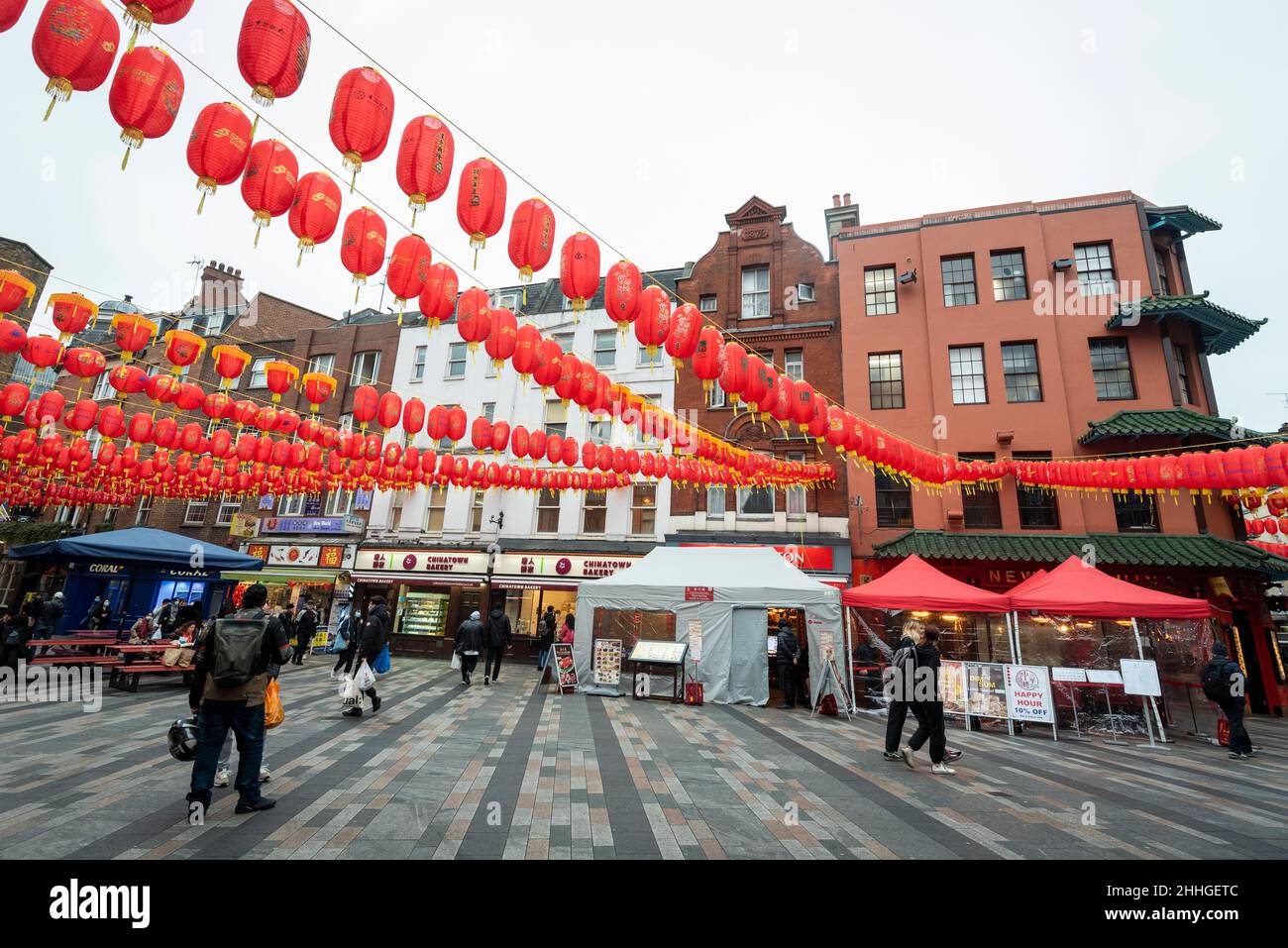 London, UK.  24 January 2022.   Assembled lanterns are hung overhead in Chinatown ahead of Chinese New Year and The Year of the Tiger officially begins on 1 February.  Festivities on Chinatown are scaled back this year to the pandemic.  Credit: Stephen Chung / Alamy Live News Stock Photo