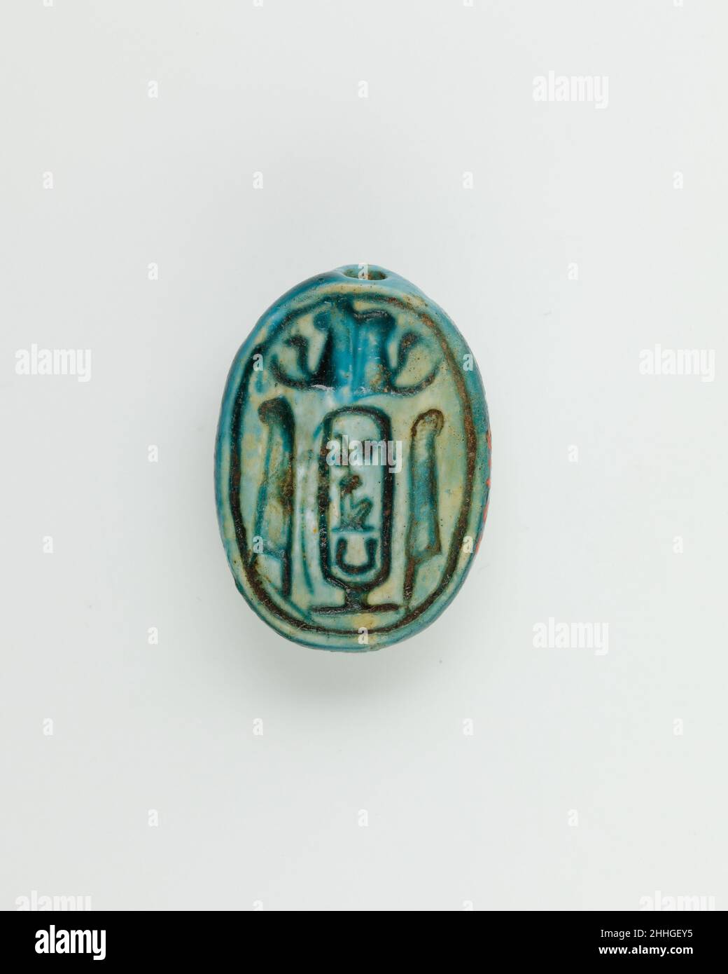 Wedjat-Eye Design Amulet Inscribed With the Cartouche Maatkare (Hatshepsut) ca. 1479–1458 B.C. New Kingdom This wedjat eye amulet is inscribed on the base with a cartouche encircling Hatshepsut's throne name, Maatkare. This is surmounted by an Atef-crown and flanked by two ostrich feathers.. Wedjat-Eye Design Amulet Inscribed With the Cartouche Maatkare (Hatshepsut). ca. 1479–1458 B.C.. Glazed steatite. New Kingdom. From Egypt, Upper Egypt, Thebes. Dynasty 18 Stock Photo