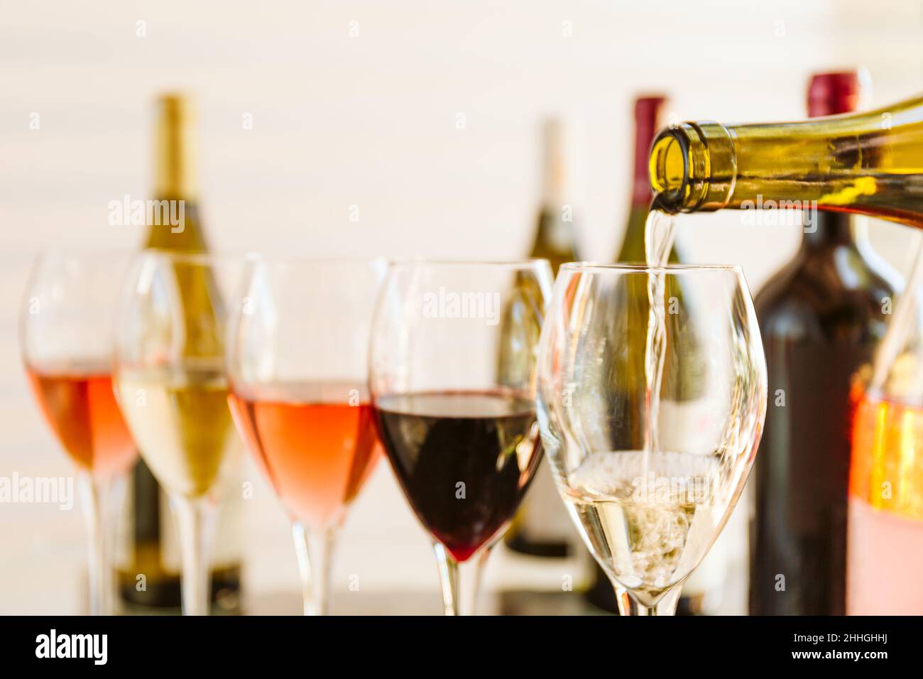 Wine tasting set in the light airy environment. Pouring into the ...
