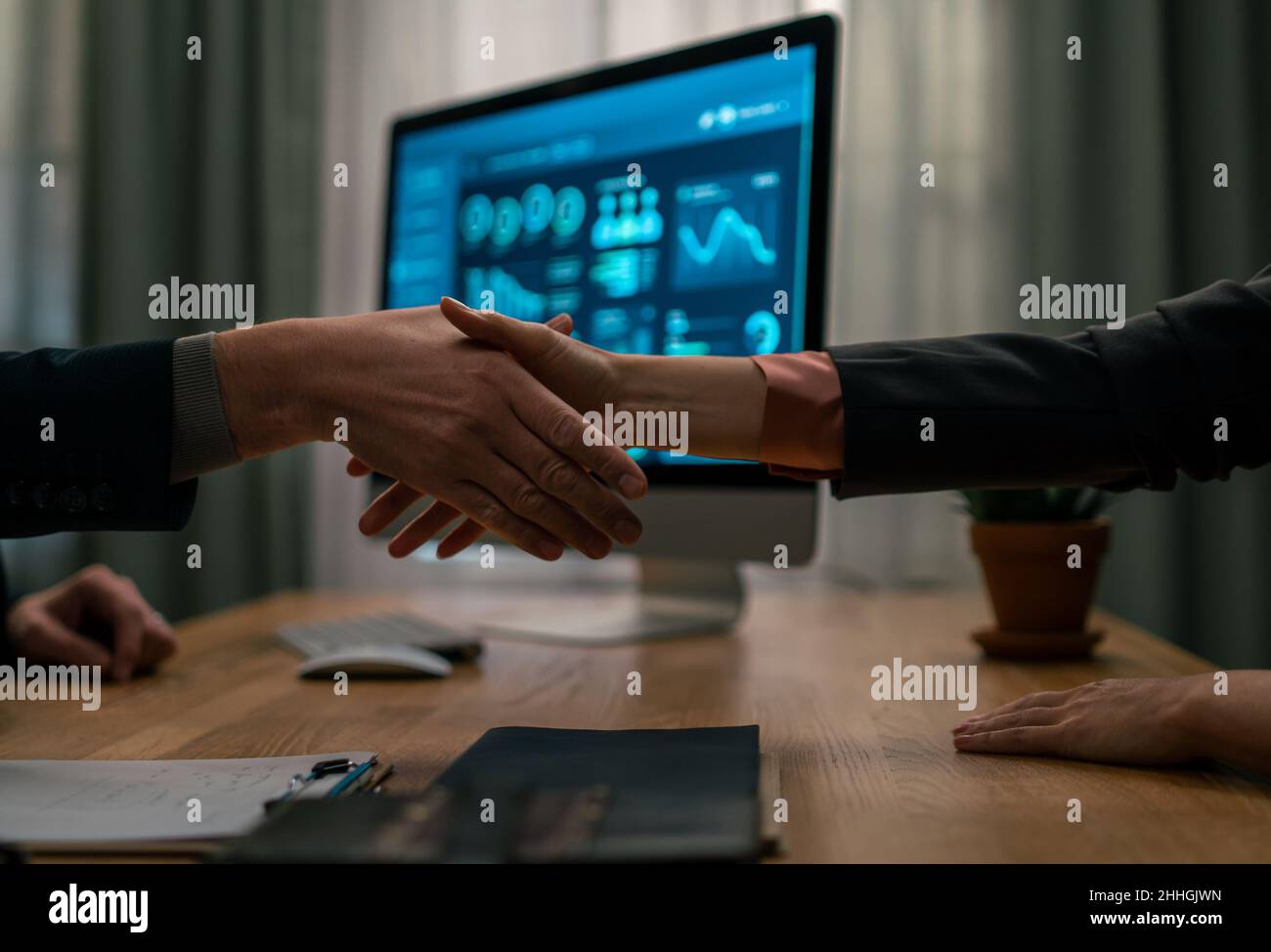 Mature financial advisor shaking hand with his client indoors in office, cut out. Stock Photo