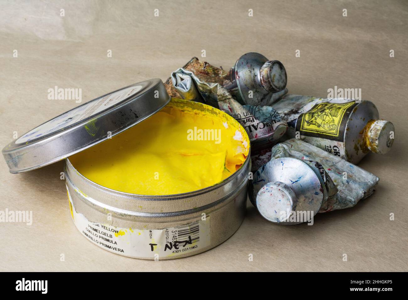 Old and used Graphic artist´s tin can of colour paint tubes Stock Photo
