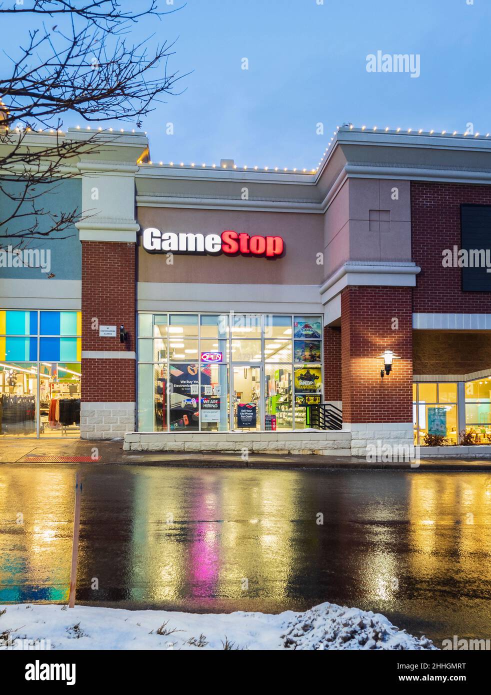 New Hartford, New York - January 23, 2022: Vertical Night View of the GameStop Video Game Storefront Stock Photo