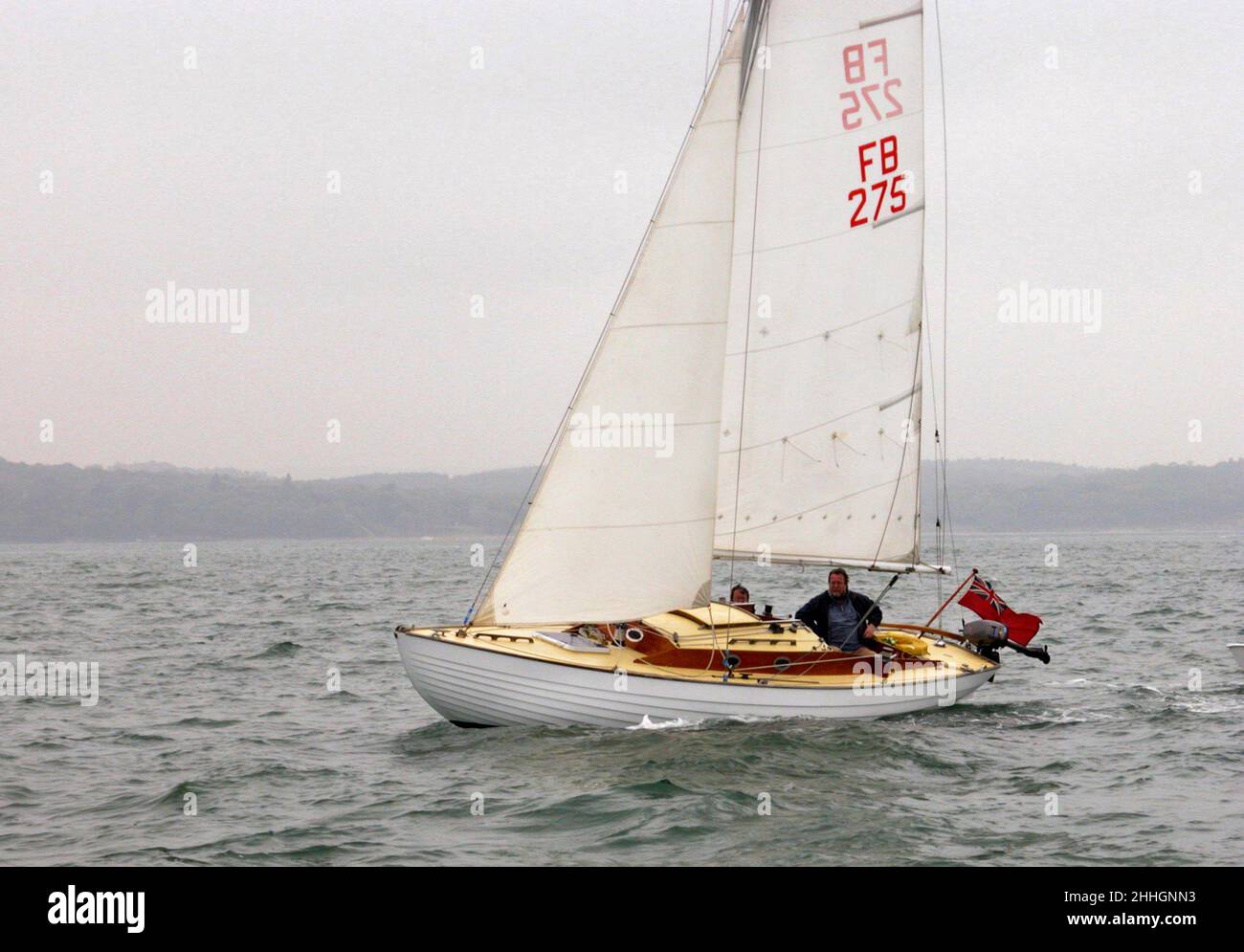 Folkboat 'Orzel' in the Solent off Wootton Creek, Isle of Wight, UK Stock Photo