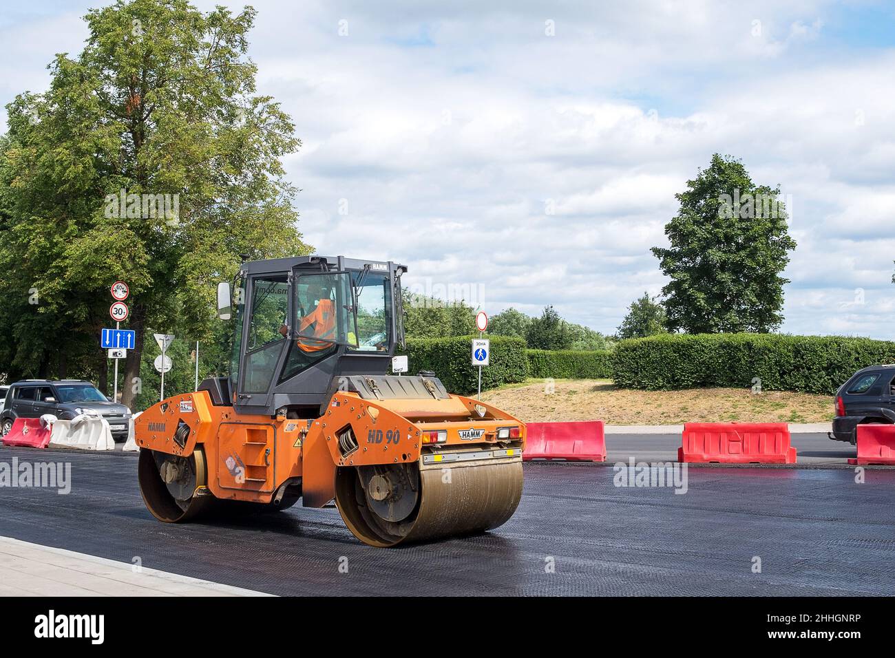 Pskov, Pskov region, Russia. - July 20, 2021. Special asphalt paving technical vehicle works on city street. Improvement of streets and roads in city. Stock Photo