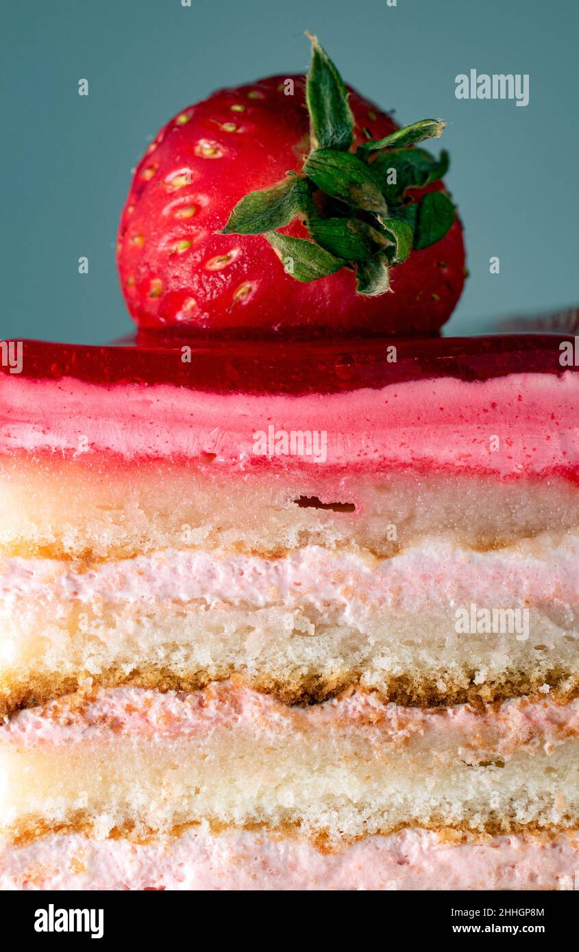Slice of strawberry and vanilla cream layered care close up Stock Photo
