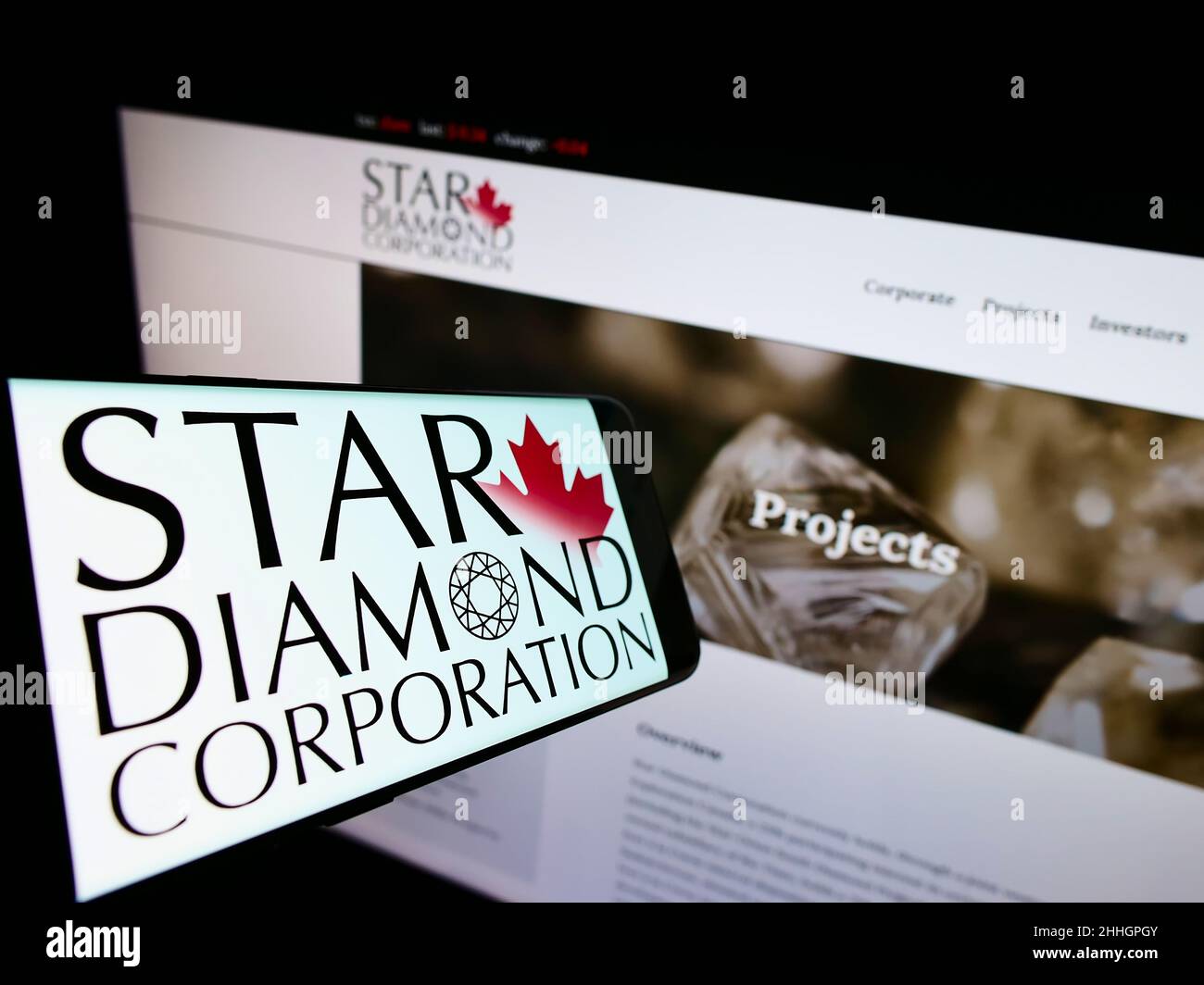 Smartphone with logo of Canadian mining company Star Diamond Corporation on screen in front of website. Focus on center-right of phone display. Stock Photo