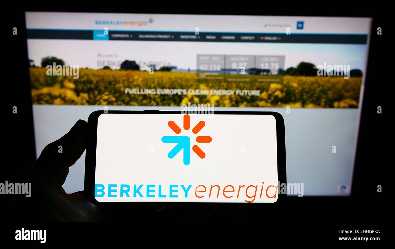 Person holding smartphone with logo of British energy company Berkeley Energia Limited on screen in front of website. Focus on phone display. Stock Photo