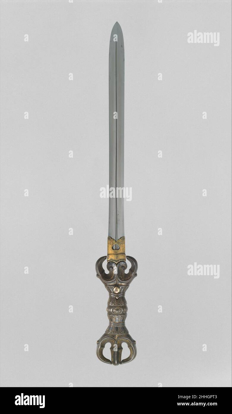 Blade and Mounting for a Double-Edged Dagger (Ken) blade, late 12th–early 13th century; mounting, 14th century Japanese The symbolic significance of the triple-pronged vajra, as well as its shape, made it an appropriate choice for use as the hilt of a sacred sword (ken), as demonstrated by this extremely rare example of an Esoteric Buddhist ritual object in the form of a ken. The blade dates from the late Heian or early Kamakura period (late twelfth to early thirteenth century), and the gilt-copper vajra hilt was probably made in the early Nambokuch? period (mid-fourteenth century). In Buddhis Stock Photo
