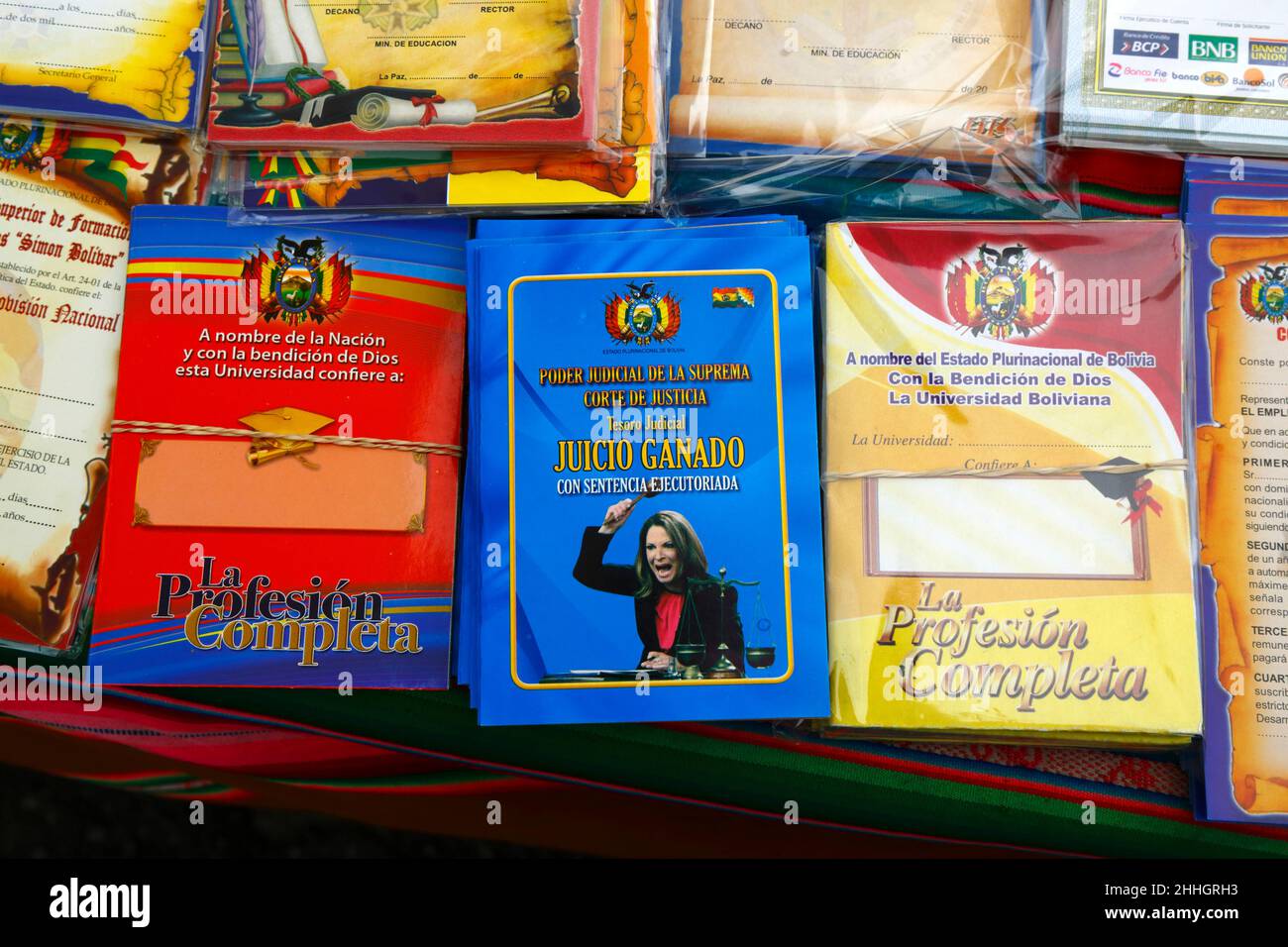 24th January 2022, La Paz, Bolivia: A verdict from the Supreme Court of Justice featuring Ana María Polo from the famous Telemundo TV series 'Caso Cerrado' ('Case Closed') and miniature certificates for sale at the Alasitas festival, which started today. Alasitas is a festival celebrated throughout the Bolivian altiplano, especially in La Paz. It has ancient origins - traditionally the Aymara people would perform rituals and offer miniatures to their gods, the idea being that these would then be received during the coming year. Stock Photo