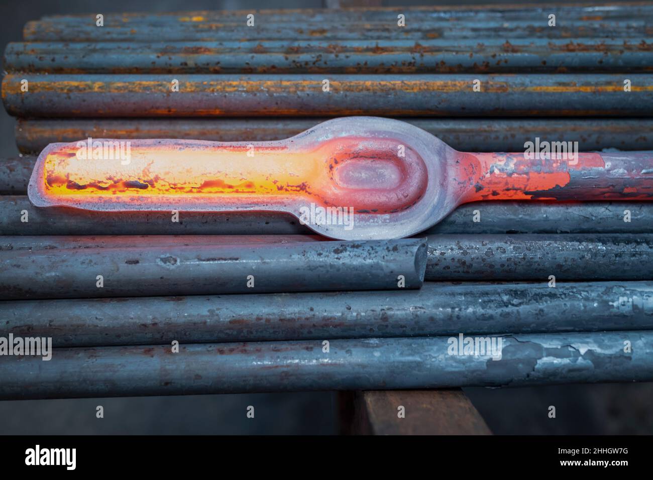 Hot forged steel part in industrial forge Stock Photo