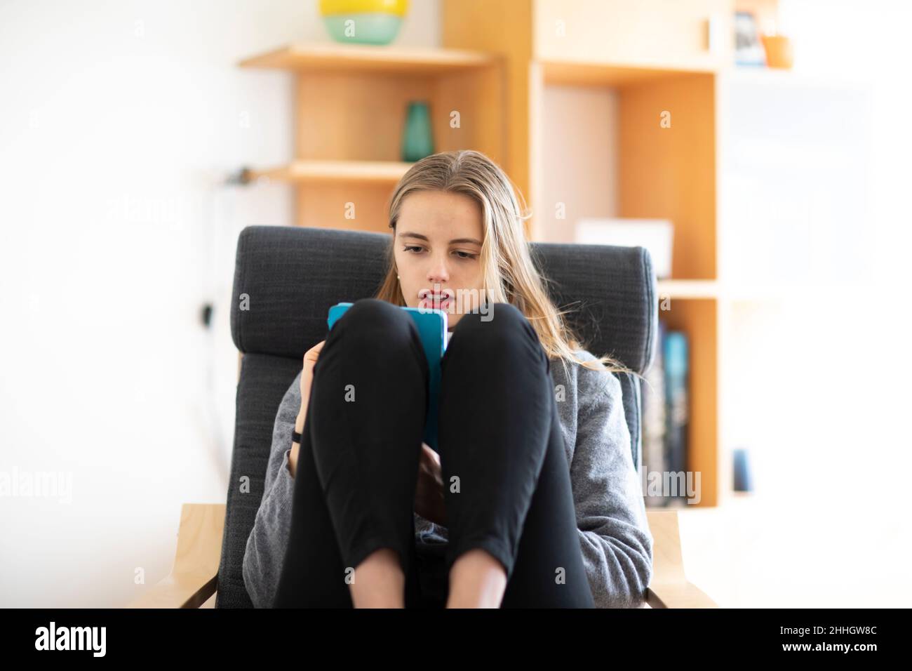 Young woman using digital tablet at home Stock Photo