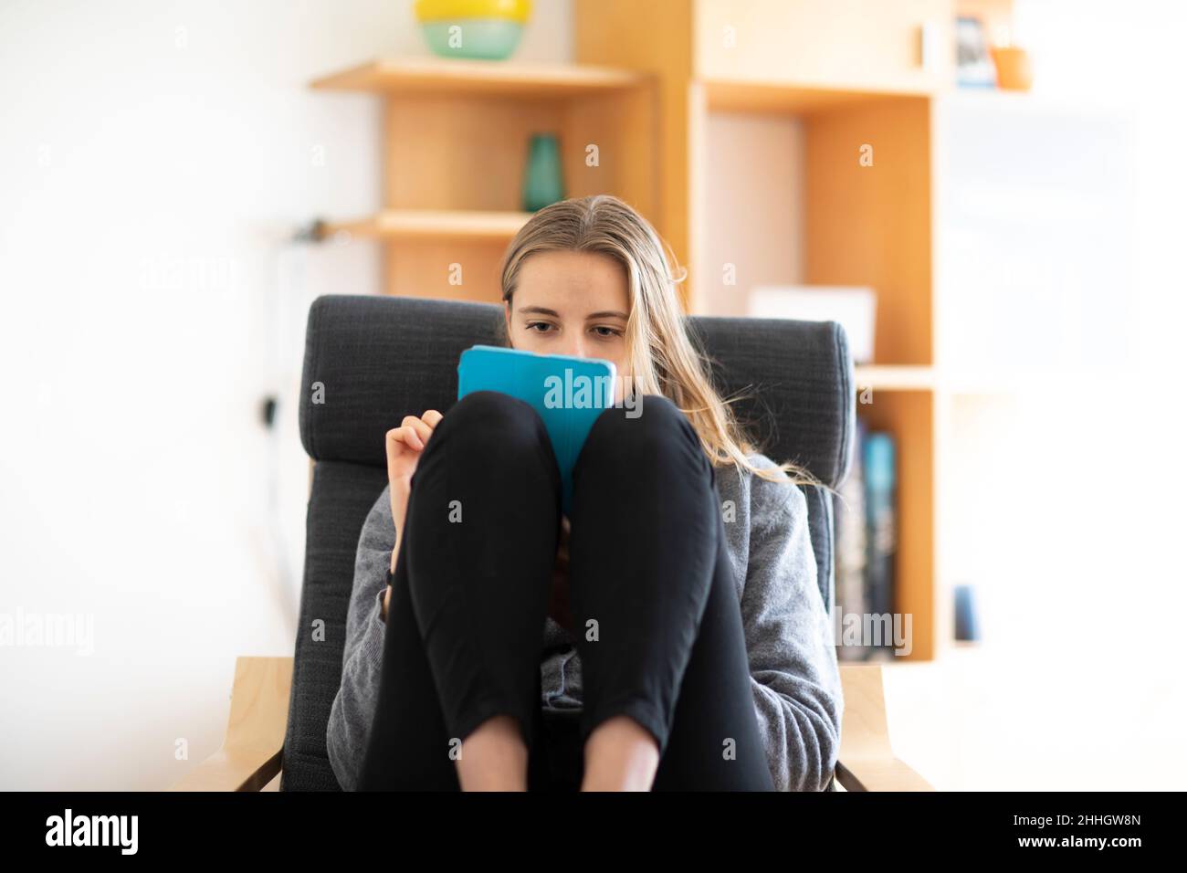 Young woman using digital tablet at home Stock Photo