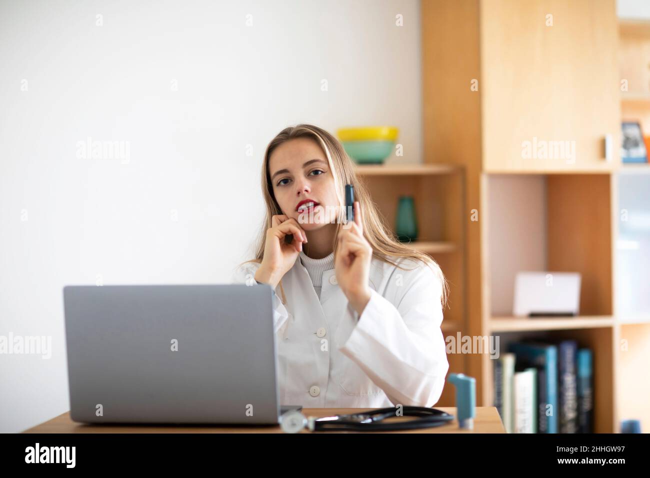 Portrait of young female doctor with laptop Stock Photo