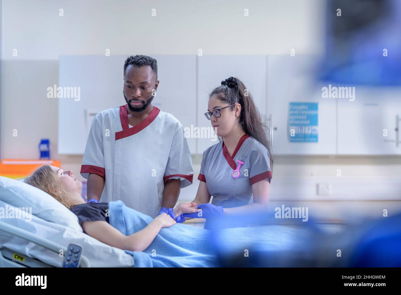 Nurses with patient in hospital ward Stock Photo