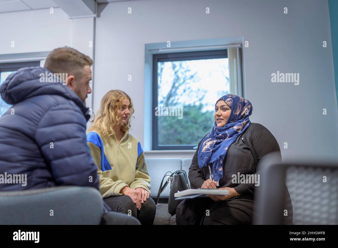 Foster care social worker in meeting with foster parents Stock Photo