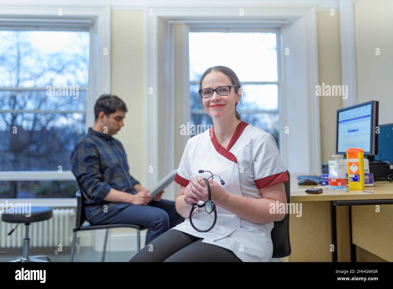 Portrait of smiling nurse in doctors office Stock Photo