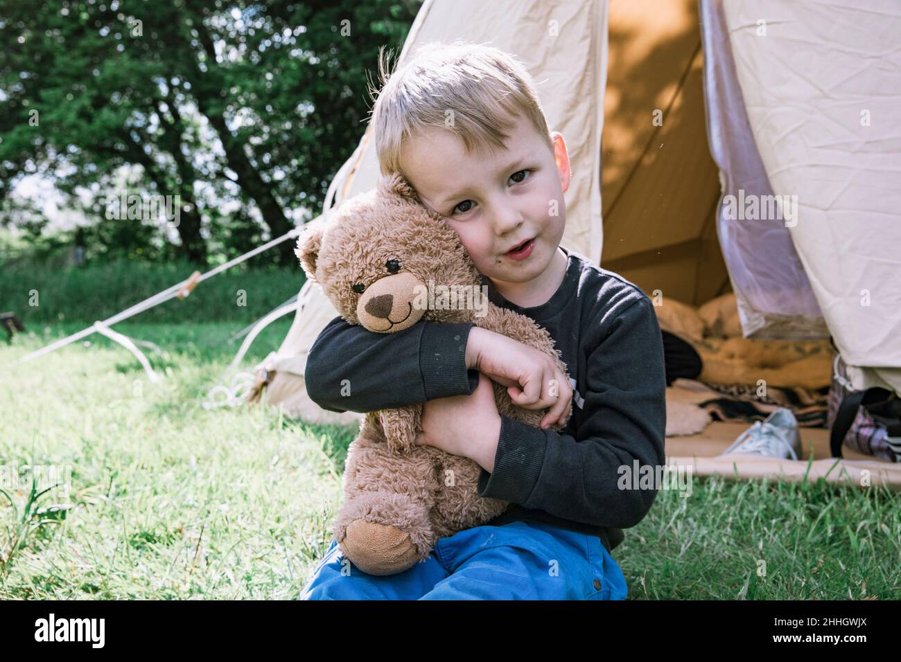 Boy hugging teddy bear hi-res stock photography and images - Alamy