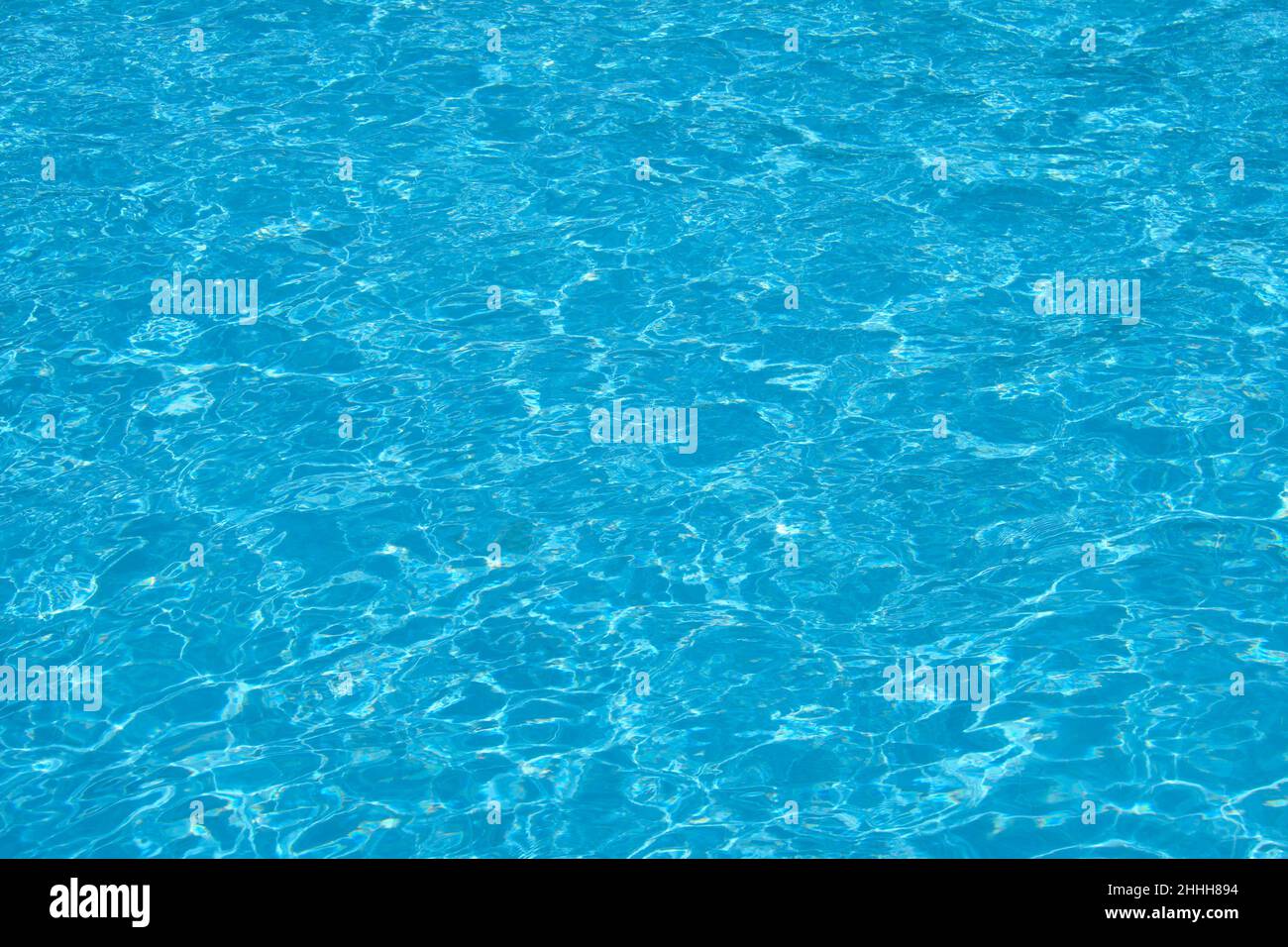 Closeup surface of blue clear water with small ripple waves in swimming ...