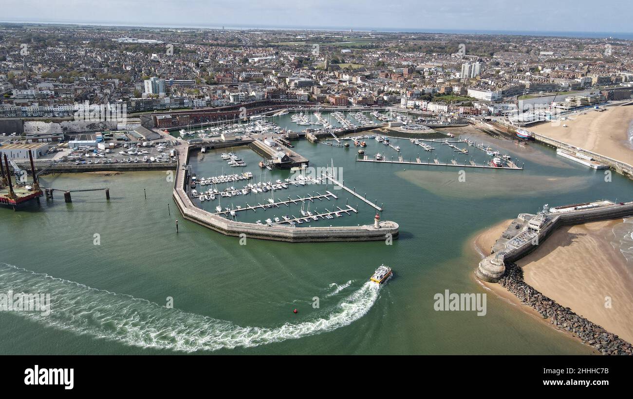 Small boat entering harbour Ramesgate Harbour Kent Uk aerial drone view bight sunny day Stock Photo